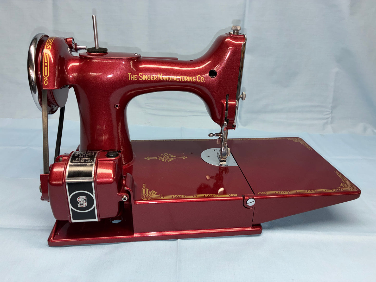 Red Singer sewing machine on a white background