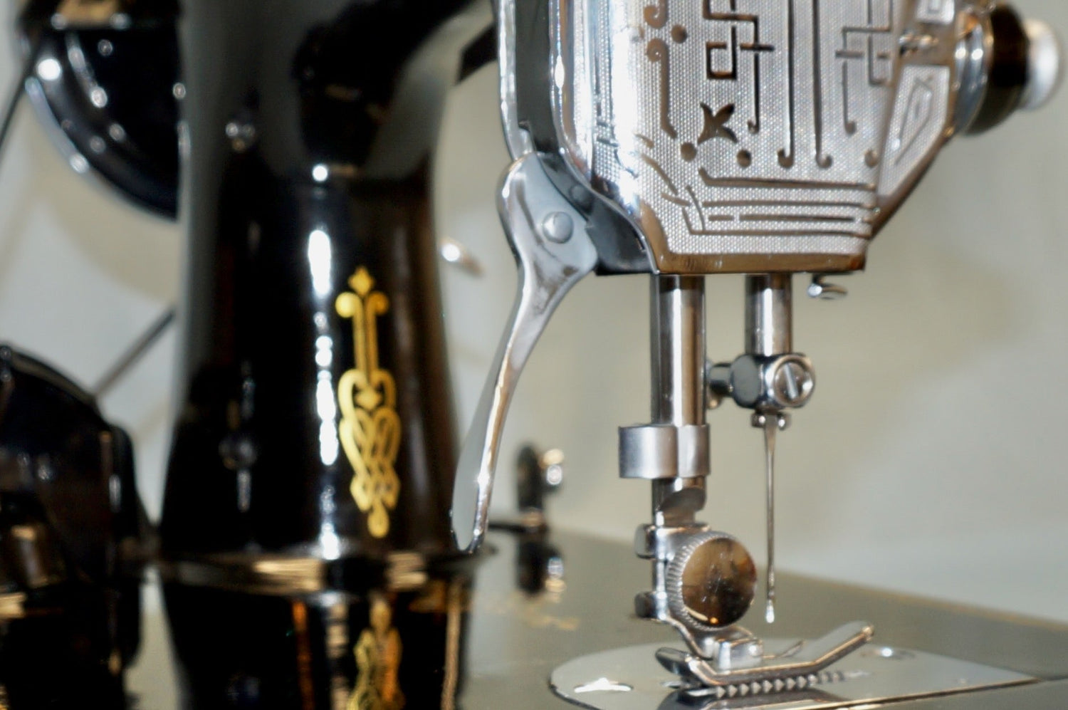 close up view of a Singer Featherweight needle area showing chrome accents