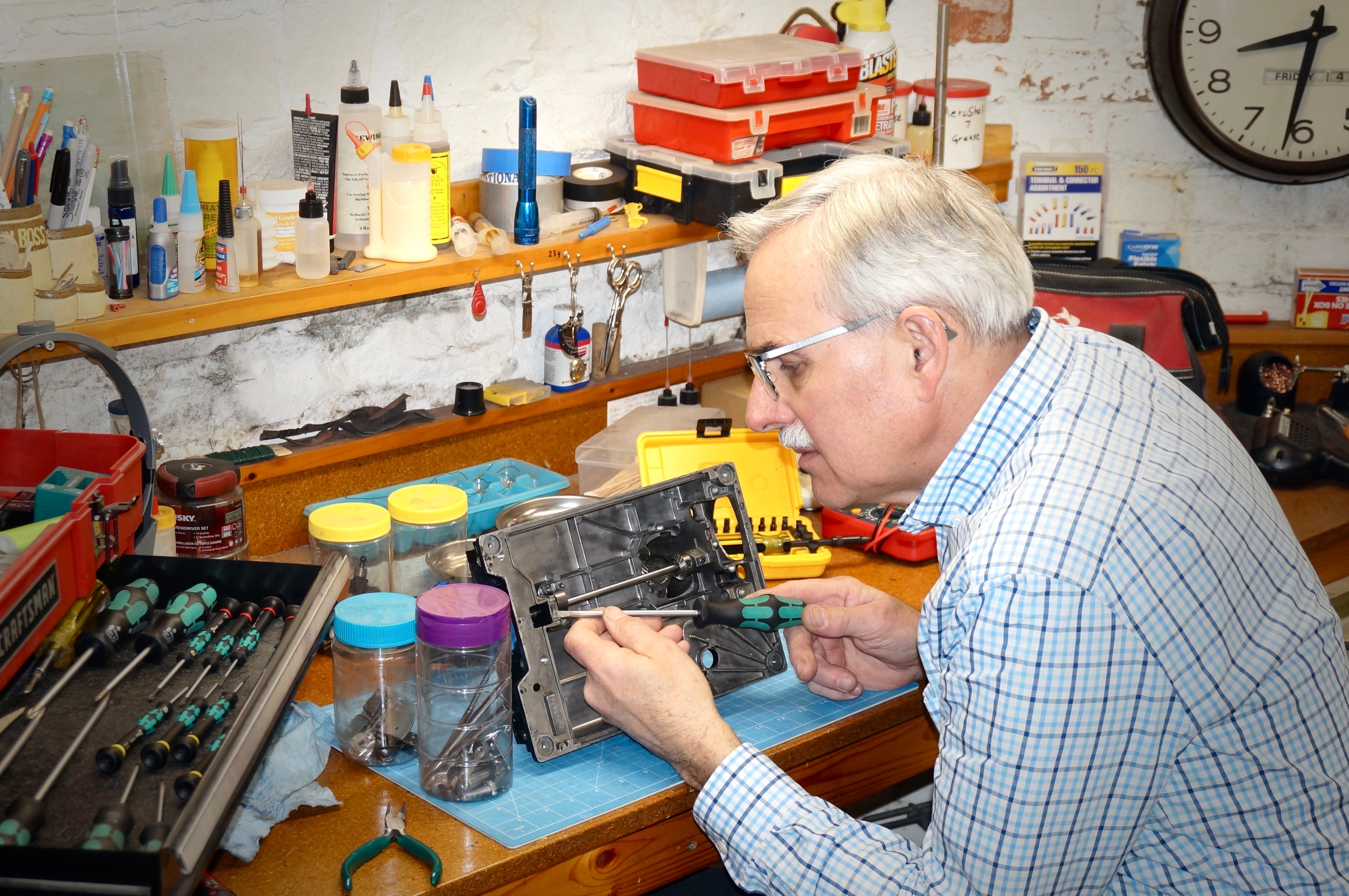 Featherweight Guy at his workbench working on the underside of a Featherweight