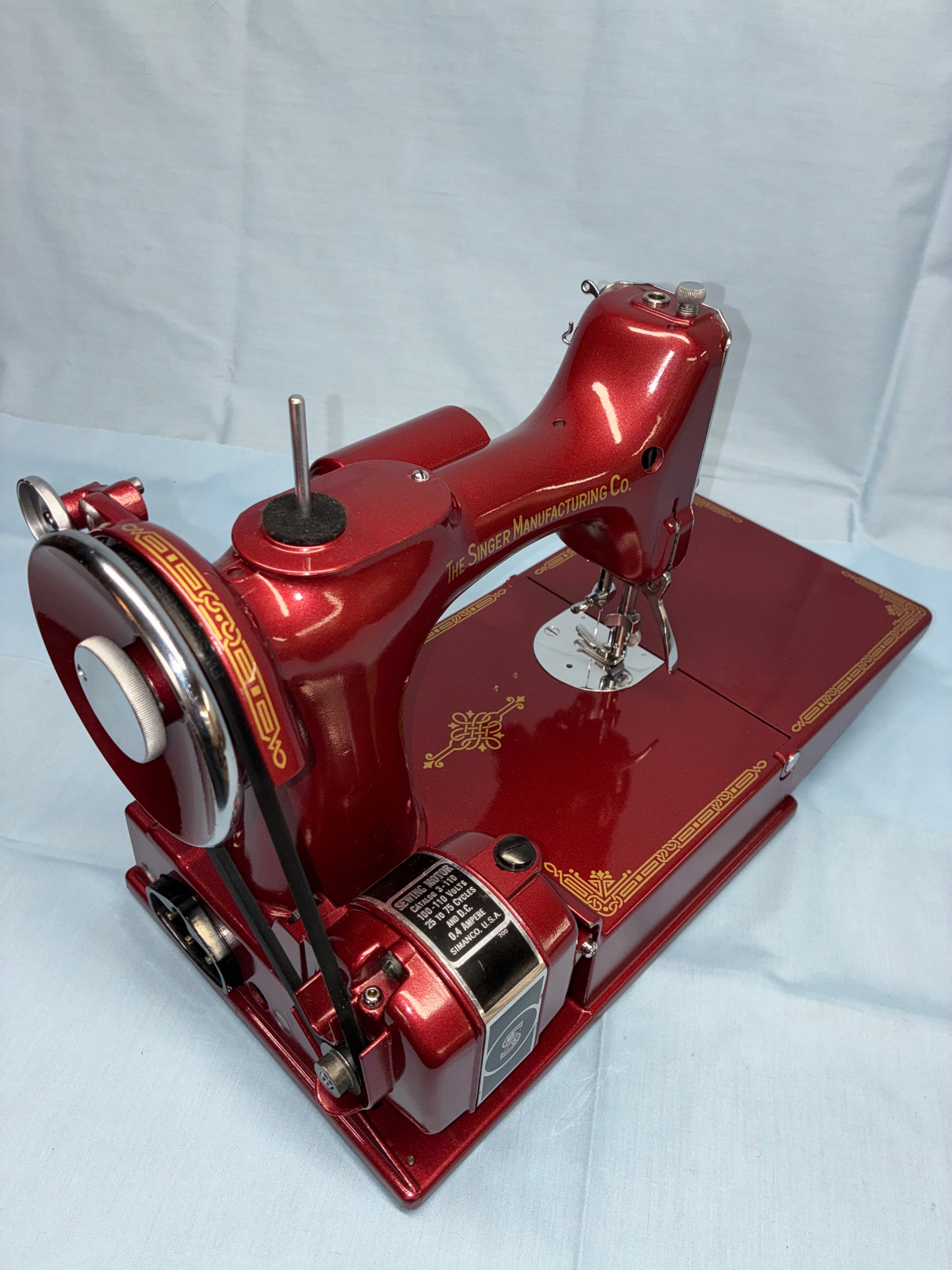 Red sewing machine on a white background