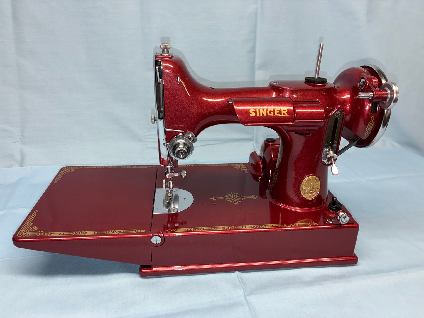 Red Singer sewing machine on a white background